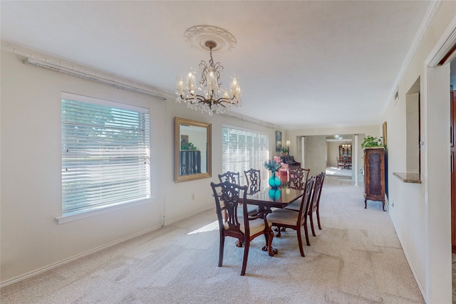 dining area with light carpet, ornamental molding, a chandelier, and plenty of natural light