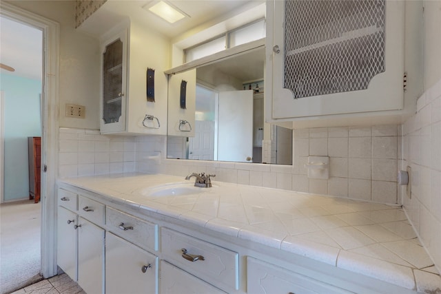 bathroom with vanity and backsplash