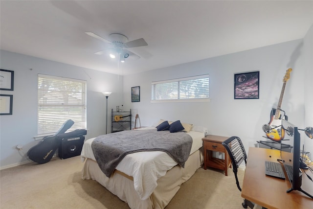 bedroom with ceiling fan and light carpet