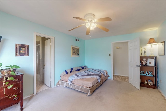 carpeted bedroom with connected bathroom and ceiling fan