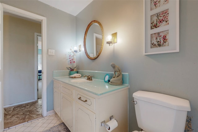 bathroom featuring toilet, vanity, and tile patterned flooring