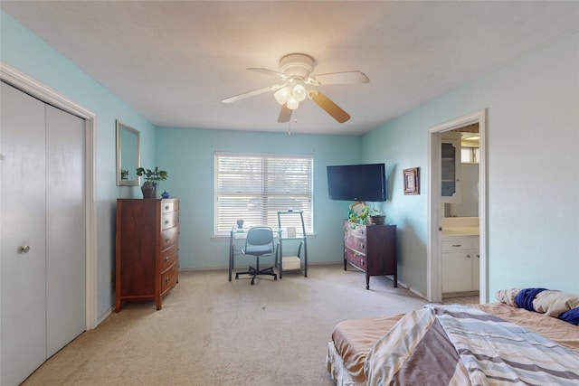 carpeted bedroom with a closet, ceiling fan, and ensuite bathroom