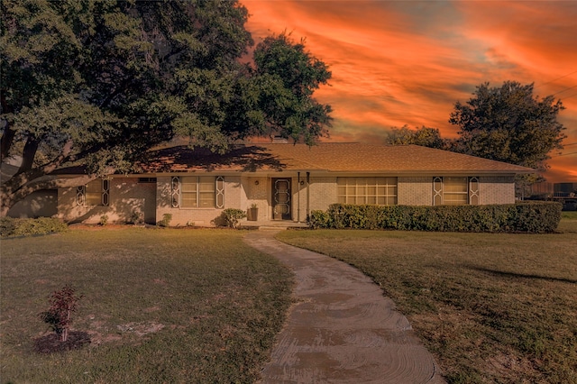 ranch-style house with a yard