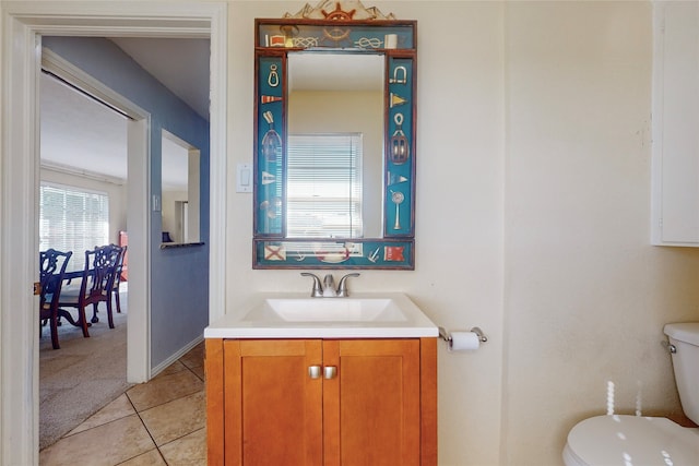 bathroom with vanity, toilet, and tile patterned floors