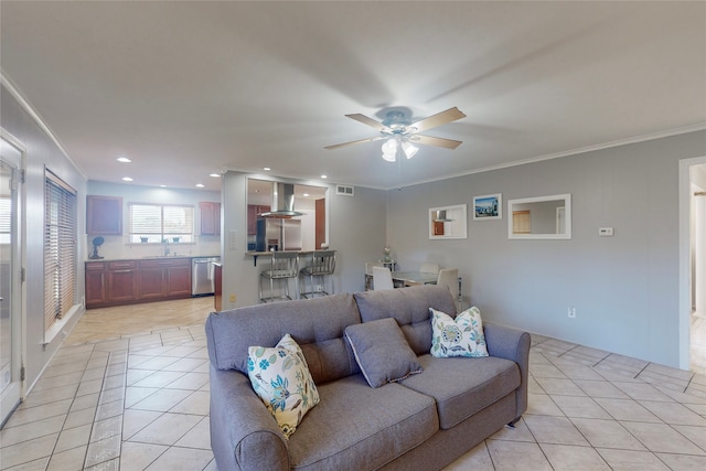 tiled living room featuring crown molding, sink, and ceiling fan