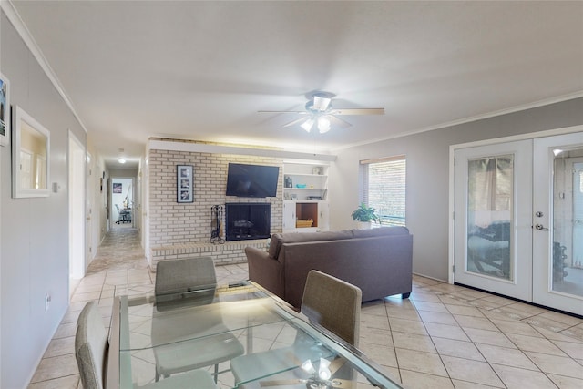 tiled dining space featuring french doors, ceiling fan, and ornamental molding