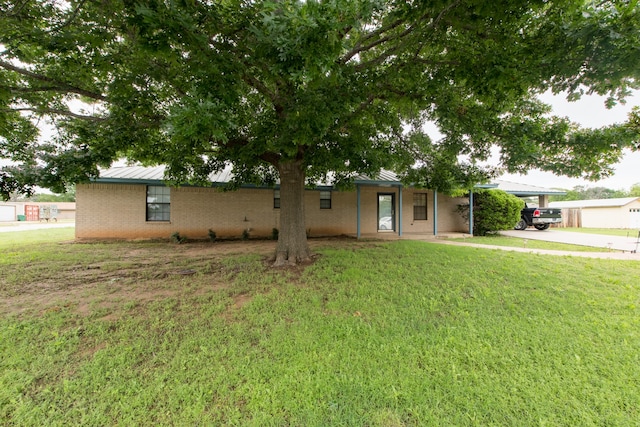 single story home with a front yard and a garage