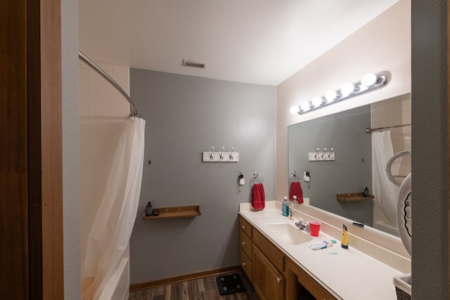 bathroom featuring vanity, wood-type flooring, and shower / bath combo