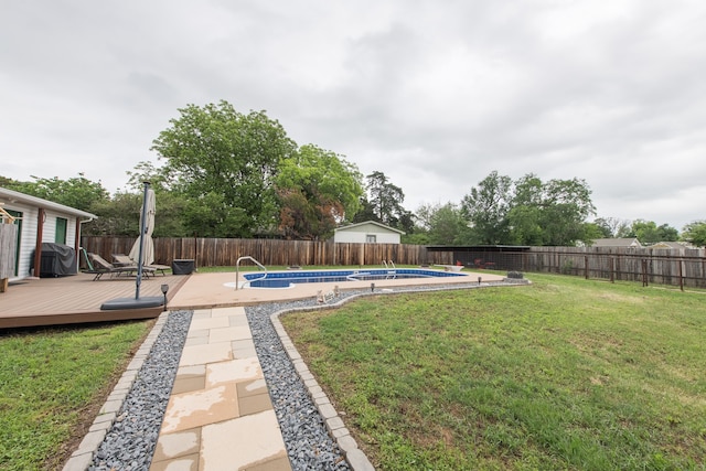 view of yard with a swimming pool side deck