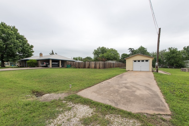 view of yard featuring a garage and an outdoor structure