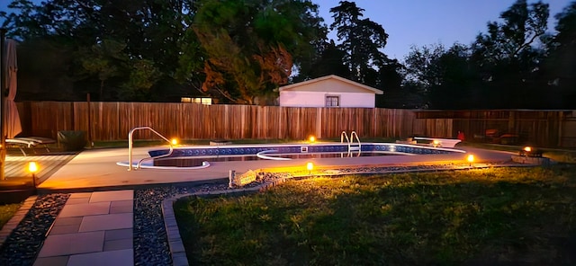 pool at dusk with a jacuzzi and a patio