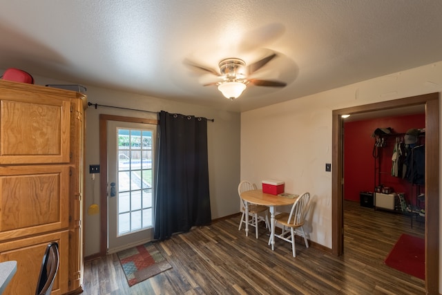 dining space featuring a textured ceiling, ceiling fan, and dark hardwood / wood-style floors