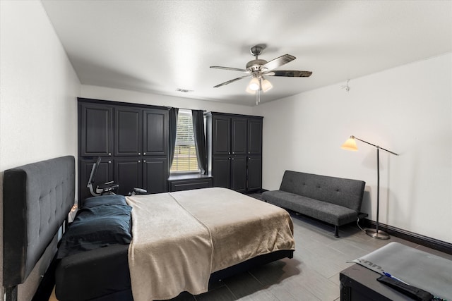 bedroom with light hardwood / wood-style flooring and ceiling fan