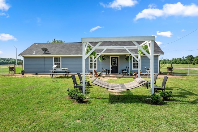 rear view of house featuring a lawn