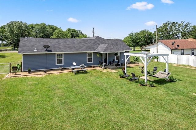 back of house with a patio and a lawn