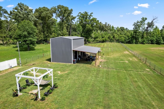 view of yard featuring a rural view and an outdoor structure