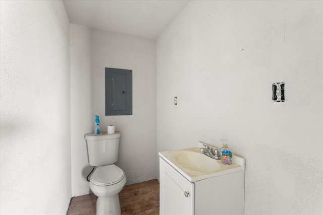 bathroom with wood-type flooring, vanity, and toilet