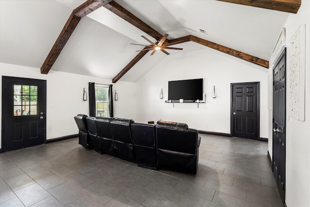 living room featuring vaulted ceiling with beams, ceiling fan, and dark tile floors