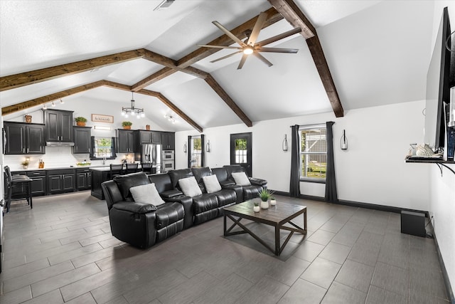 living room with ceiling fan with notable chandelier, beam ceiling, and high vaulted ceiling