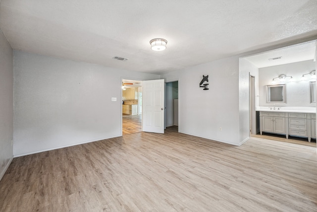 empty room featuring light hardwood / wood-style flooring and sink