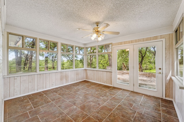 unfurnished sunroom featuring ceiling fan