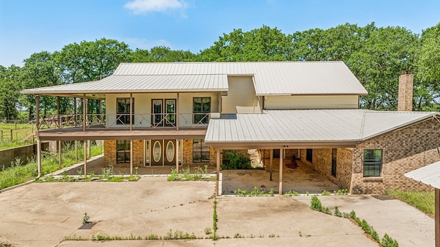 view of front of home with a carport and a porch