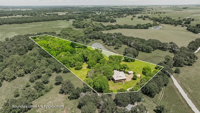 birds eye view of property with a rural view