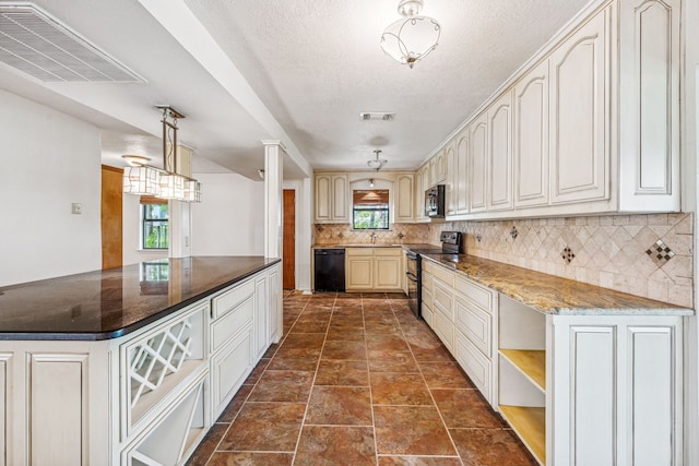 kitchen with hanging light fixtures, black appliances, tasteful backsplash, sink, and dark tile floors