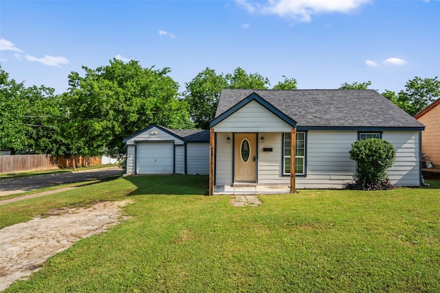 view of front facade with a front lawn, an outbuilding, and a garage