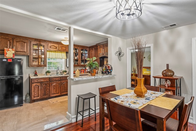 dining room featuring sink and light wood-type flooring