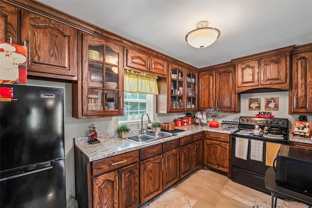 kitchen with sink, black appliances, and light stone countertops