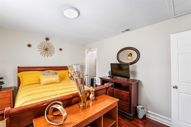 bedroom with dark wood-type flooring