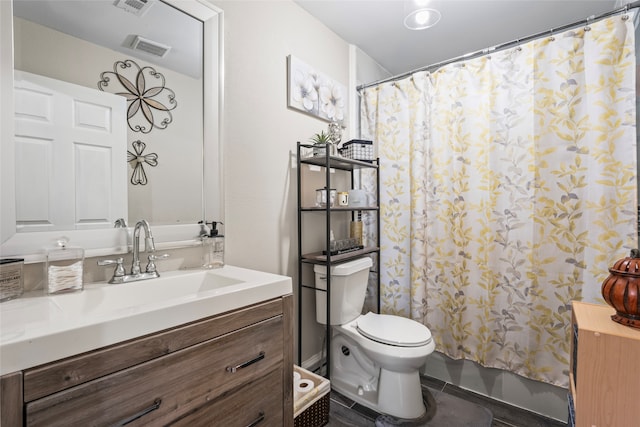 full bathroom with vanity, shower / tub combo, and toilet