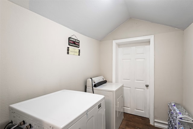 laundry room featuring radiator, dark wood-type flooring, and washer and clothes dryer