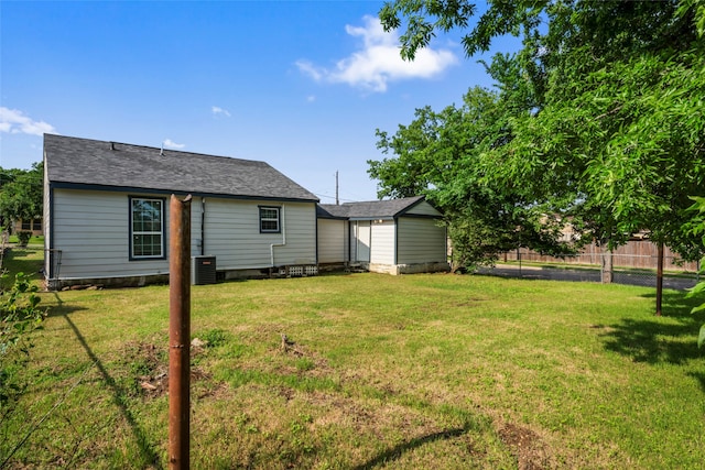 view of yard with a storage shed and central AC unit