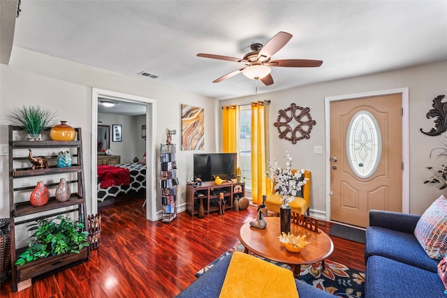 living room featuring hardwood / wood-style floors, a textured ceiling, and ceiling fan