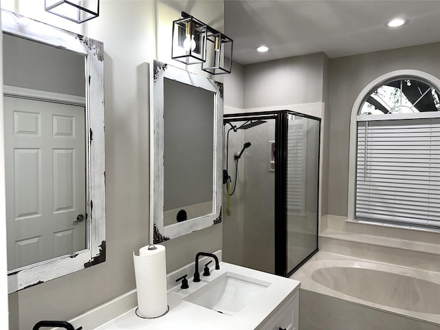 bathroom featuring vanity, plus walk in shower, and a chandelier