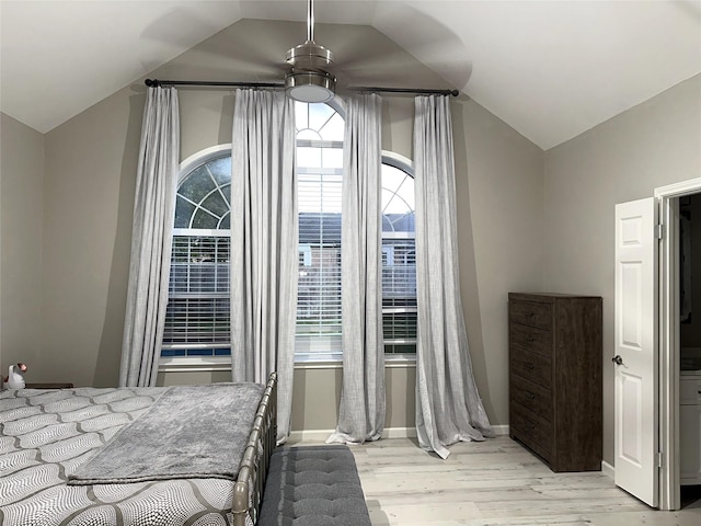 bedroom with ceiling fan, light hardwood / wood-style flooring, and lofted ceiling