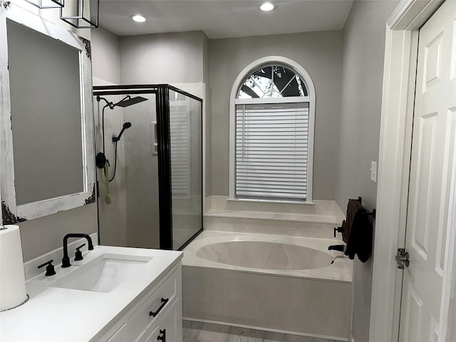 bathroom featuring vanity and separate shower and tub