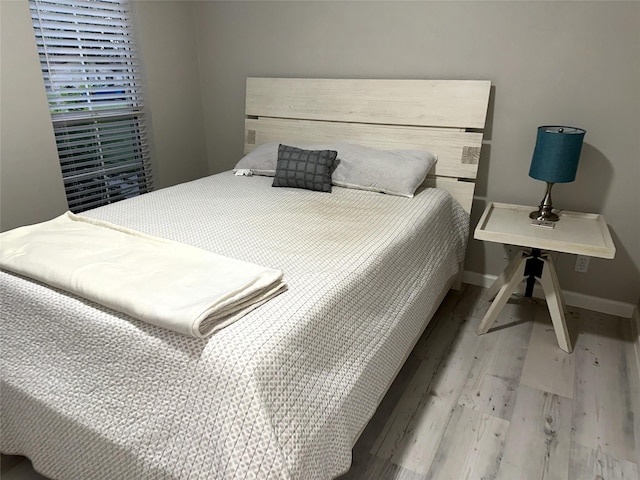 bedroom with hardwood / wood-style flooring