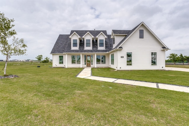 new england style home with a lawn