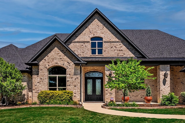 view of front of property featuring a front lawn and french doors