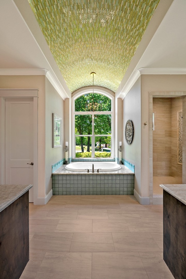 bathroom featuring tile patterned floors, crown molding, vanity, and plus walk in shower