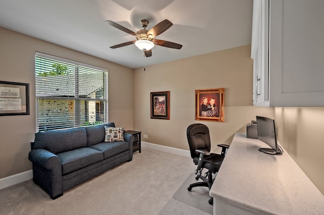 home office with light carpet and ceiling fan