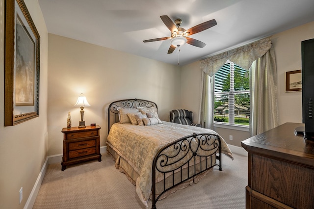 bedroom with ceiling fan and light carpet