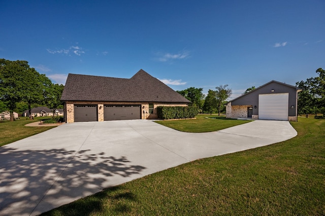 view of front of property with a garage and a front lawn