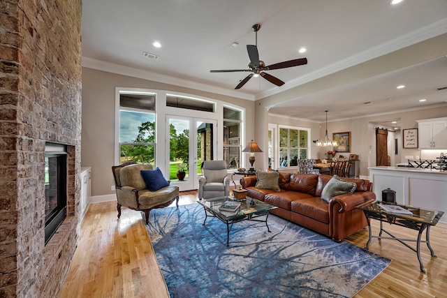 living room with french doors, light hardwood / wood-style floors, and ornamental molding