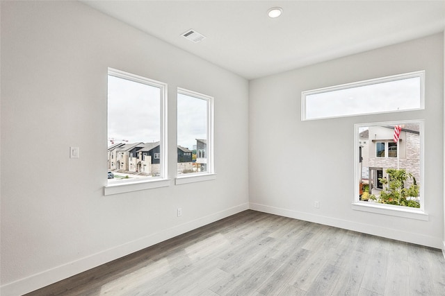 spare room featuring light hardwood / wood-style floors