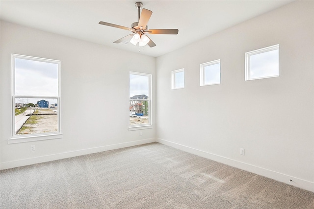 unfurnished room featuring ceiling fan, a healthy amount of sunlight, and carpet floors