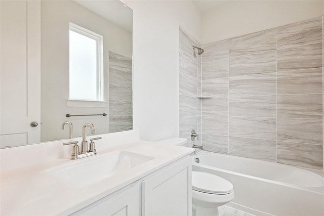 full bathroom featuring vanity, toilet, and tiled shower / bath combo